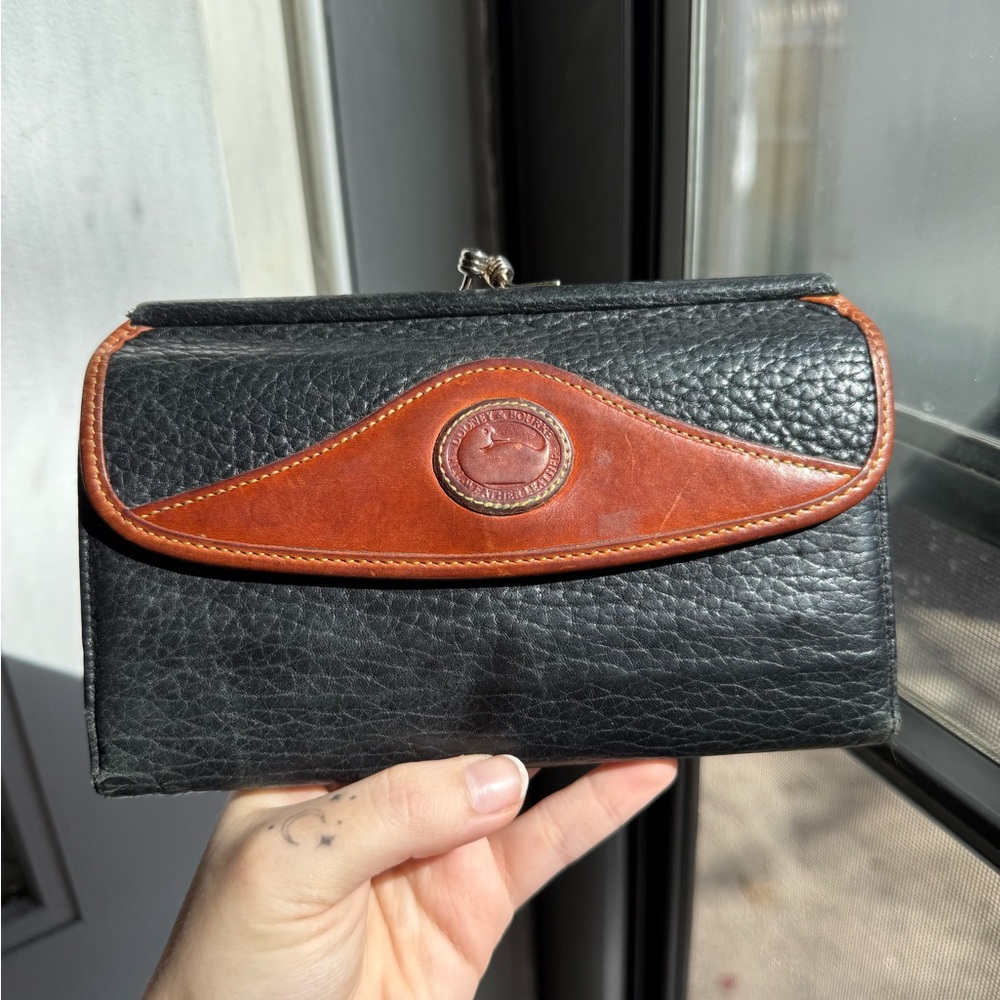 Dooney & Bourke Black Pebbled Leather Wallet with Brown Trim and Logo